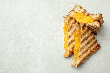 Grilled sandwiches on white textured background, space for text