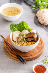 Bak chor mee. The noodles are tossed in vinegar, minced meat, pork slices, pork liver, stewed sliced mushrooms, meat balls and bits of deep-fried lard