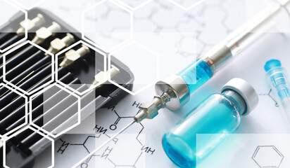 small jars with injection and syringe for injection on a blue background near the chemical formula