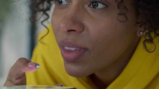 Close up view optimistic mixed race girl sit indoors make short phone call by speakerphone, Black woman using telephone leaving voice message