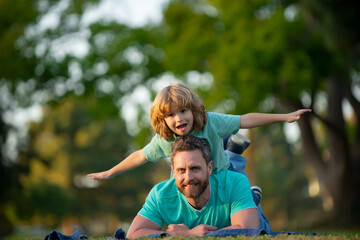 Dad and child having fun outdoors. Concept of healthy holiday and family activity.
