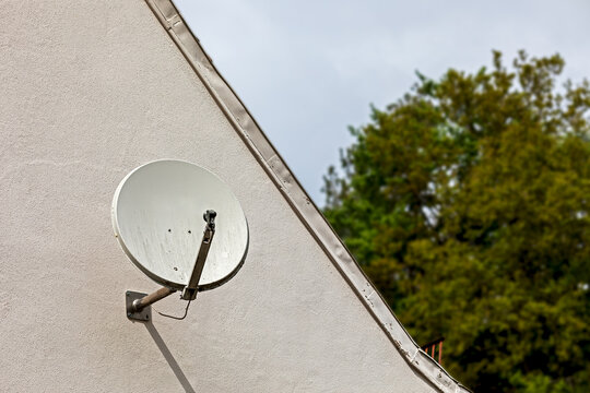 satellite dish on a house wall