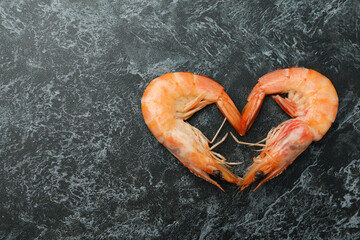 Heart made of shrimps on black smokey background