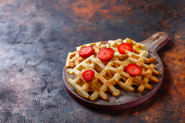 Homemade belgian waffles with strawberries.