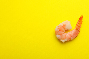 Tasty shrimp on yellow background, space for text