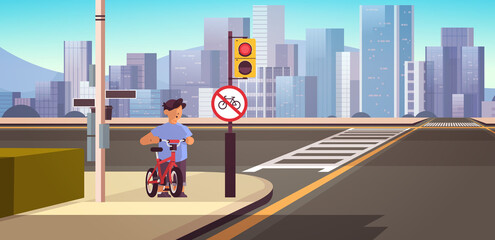 schoolboy with bicycle standing near red round ban sign road safety concept horizontal cityscape background