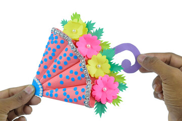 One crafted handmade umbrella made for small children held-ed by a person with his hand