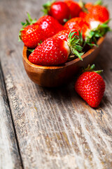 Ripe strawberries in a wooden bowl