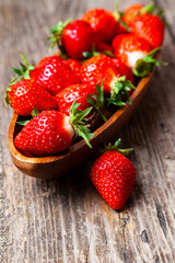 Ripe strawberries in a wooden bowl