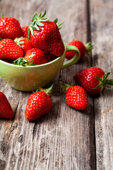 Ripe strawberries in a green cup