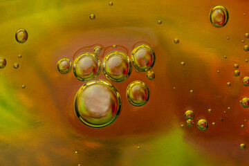 Liquid art background with oxygen bubbles. Abstract textured neon background of slime. Macro photo of slime toy for kids.