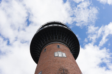 Fototapeta na wymiar Old Water Tower with Clouds and Blue Sky in Svetlogorsk, Russia