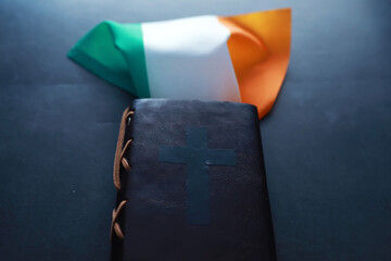 A leather-bound Bible on the table. Religious Christian Irish celebration. Four-leaf clover symbol of good luck.