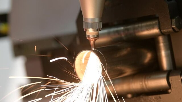 Fiber laser tube cutting machine. metal pipe cutting with sparks