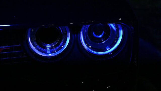muscle car headlights reflecting flashing police lights