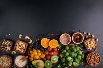 Different vegetables, seeds and fruits on table. Healthy diet..vegetarian, vegan food cooking ingredients. Flat-lay of vegetables, fruit, beans, cereals, kitchen utencil, dried flowers, top view.