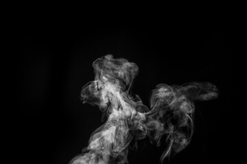 Perfect mystical curly white steam or smoke isolated on black background. Abstract background fog or smog