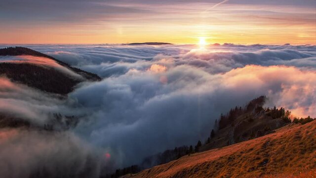 Sunset in autumn mountains above the clouds during the weather inversion in Slovakia. Time lapse landscape.
