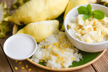 Asian Thai dessert tropical sweet durian peel with yellow bean, Ripe durian rice cooked with coconut milk, Durian sticky rice summer tropical fruit food.