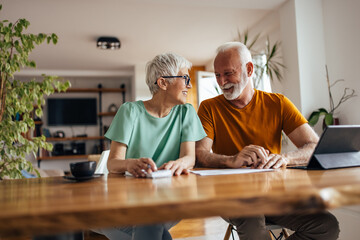 Mature husband, talking to his wife, while working.