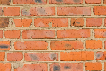 Weathered red stained old brick wall background