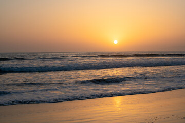 Fototapeta na wymiar Sunset in the sea with beautiful clouds. Sunrise ocean seascape.
