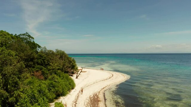 Beautiful beach on tropical island surrounded by coral reef, top view. Mantigue island. Small island with sandy beach. Summer and travel vacation concept, Camiguin, Philippines, Mindanao