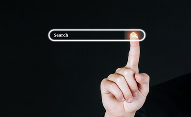 Searching. business customer hand pressing visual screen search button with copy space on dark background, searching browsing information, internet data technology and data search engine concept