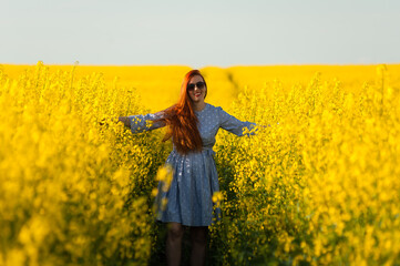 Fototapeta premium Beautiful pregnant woman portrait on the agriculture field