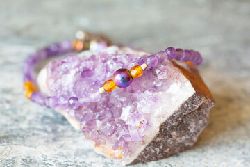 Amethyst and hematite mineral stone bracelet on natural background