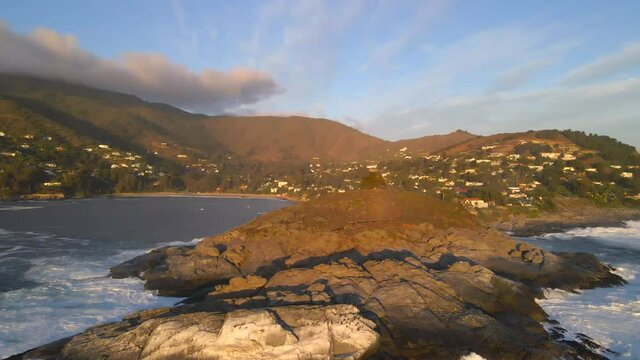 AERIAL - Beautiful sunny Cerro de la Cruz, Zapallar, Chile, wide spinning shot