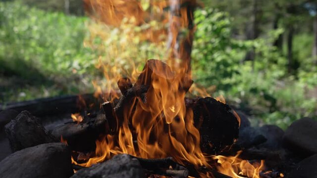 Slow Motion Of A Burning Wood Bonfire With Swirling Orange Flames. - Close Up Shot
