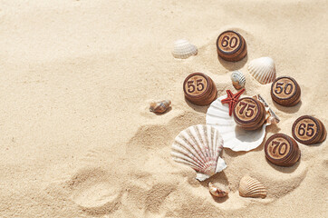 barrels with numbers on the sand with shells for the summer sale
