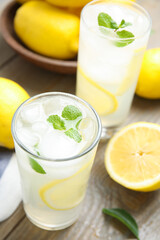 Glasses of cold lemonade on wooden table, above view