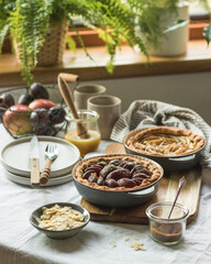 Plum and apple tart on the kitchen on the table with linen tablecloth, summer tart