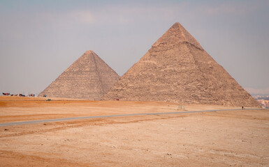 Obraz na płótnie Canvas Closeup panorama of the pyramids in Giza, Egypt on a foggy day
