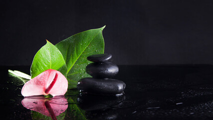 Zen concept balancing dark stones on mirrored background