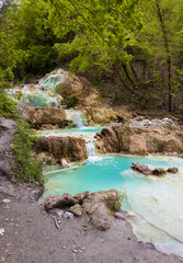 Naklejka premium Bagni San Filippo (Italy) - In Tuscany region on Monte Amiata, it's a public and wild small hot waterfall with white stone deposits named Balena Bianca.