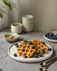 Waffles with blueberry on table with linen tablecloth, still life, slow living breakfast