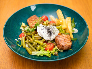 salad with meat, eggs and fries