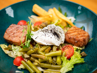 salad with meat, eggs and fries