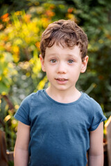 a boy in flowers, a child among the bushes