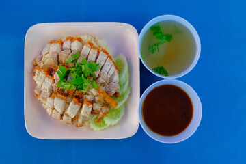 Crispy Pork Rice with gravy with clear soup is very famous street food in the morning. 