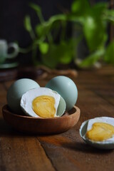 salted egg slices on a wooden table