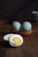 salted egg slices on a wooden table