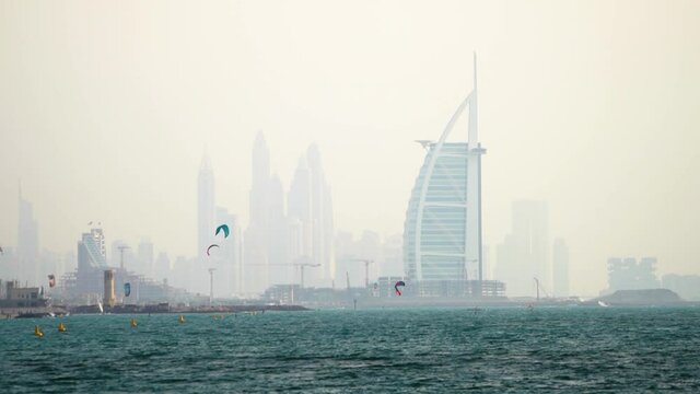The iconic Dubai Skyline forms the backdrop for kite surfers at Fazza beach. 