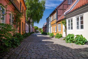 Aarhus, Denmark; May 30th, 2021 - Colourful old cottages on a quiet street in Aarhus, Denmark