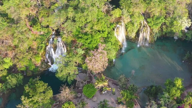 Aerial view of  amazing Tamasopo waterfalls surrounded by trees in San Luis Potosi, Mexico.