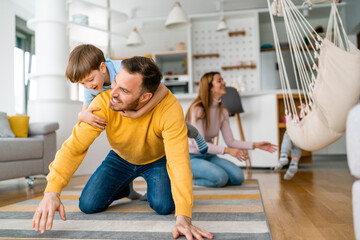 Happy young family having fun times and playing together at home