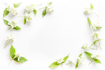 Naklejka premium Floral frame pattern. Blossom jasmine flowers flat lay. Top view